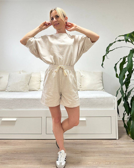 Model trägt den bequemen Damen lockeres Oversized T-Shirt mit weiten Armen in Beerenfarbe, Shorts mit Schnurdetail in Teile und Seitentaschen aus 95 % Baumwolle, 5 % Polyester, Set ist in Einheitsgroesse XS bis XL von Nella Fashion Shop