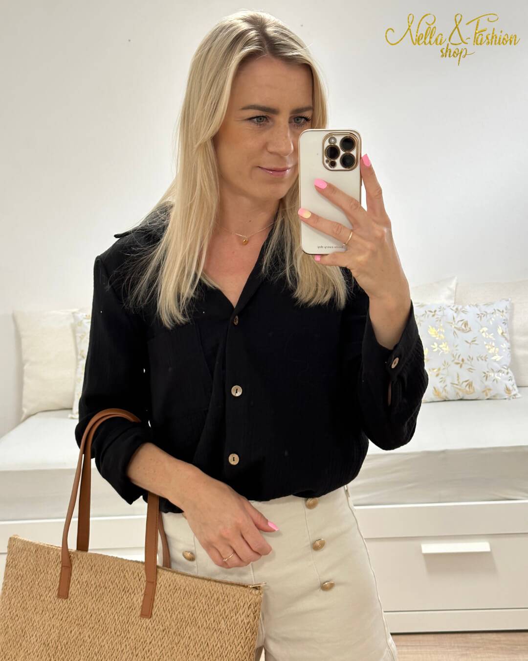 Model präsentiert den Langarm Damen Musselin Hemd aus 100 % Baumwolle in Schwarz. Leicht, locker und elegant Sommerhemd für Damen aus Musselin. In Oversized-Schnitt und Brusttasche, sowie Seiten Schlitz. Erhältlich in XS/S und M/L, Schwarz und Beige bei Nella Fashion Shop. Hintergrund Weiß.